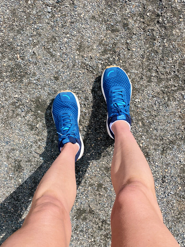 Person's legs wearing Hilma Running Shoes in Blue